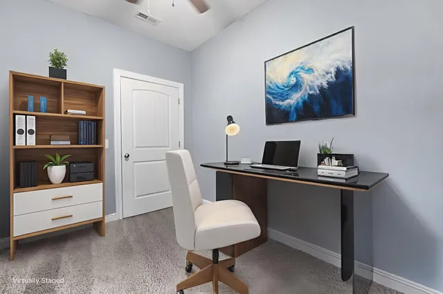 a view of a workspace with furniture