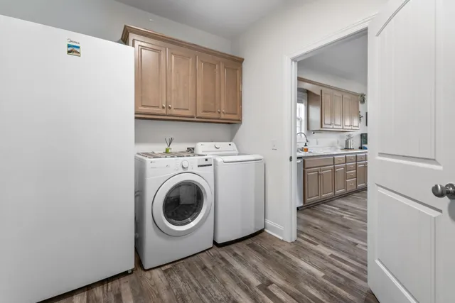 a utility room with sink dryer and washer