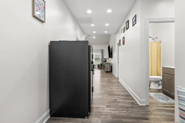 a view of a hallway with wooden floor