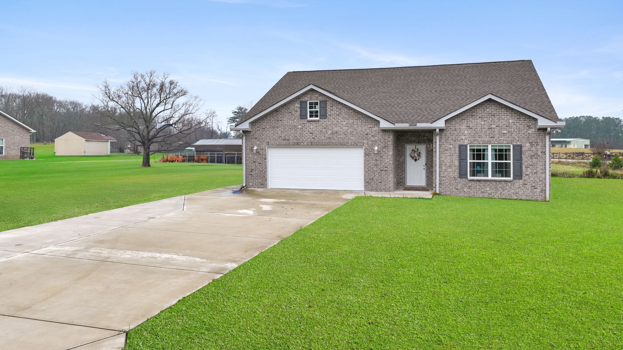 22 Hickory Drive Manchester, TN 37355 - Photo 36 of 37 a front view of a house with a yard and garage