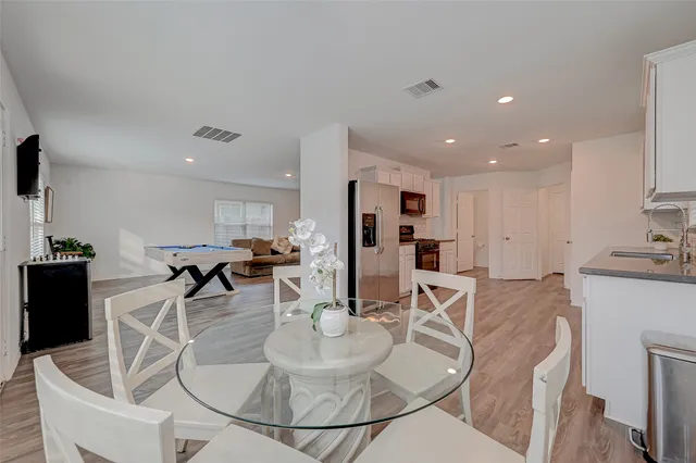a living room with furniture a dining table and chairs