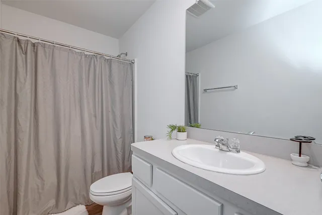 a bathroom with a sink toilet and a mirror