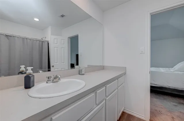 a bathroom with a sink and a mirror