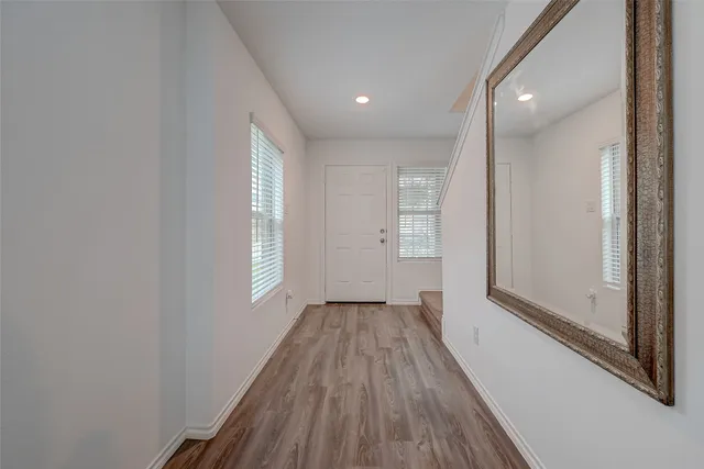 a view of a room with wooden floor and window