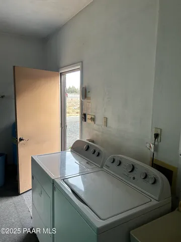 a backyard of a house with potted plants and palm trees