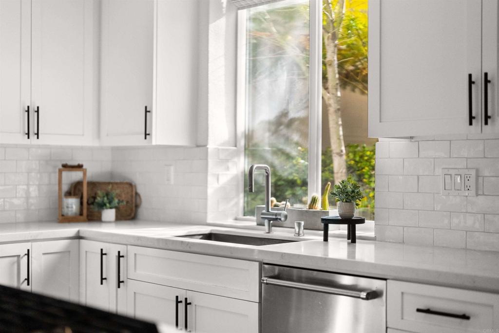 7100 Surfbird Circle Carlsbad, CA 92011 - Photo 14 of 65 a kitchen with appliances cabinets and a sink