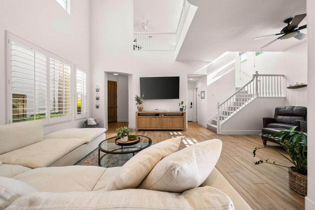 7100 Surfbird Circle Carlsbad, CA 92011 - Photo 3 of 65 a living room with furniture flat screen tv and a large window