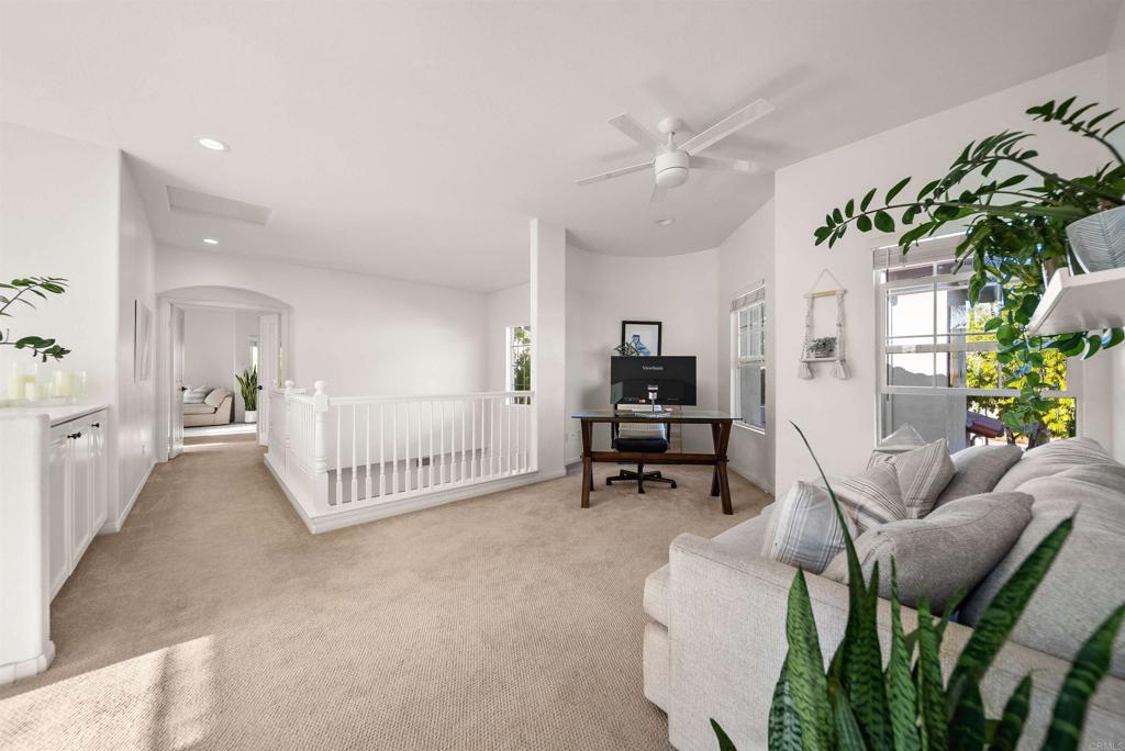 7100 Surfbird Circle Carlsbad, CA 92011 - Photo 32 of 65 a living room with furniture and a chandelier