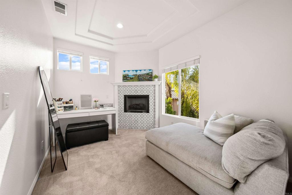 7100 Surfbird Circle Carlsbad, CA 92011 - Photo 37 of 65 a bedroom with a bed and a fireplace