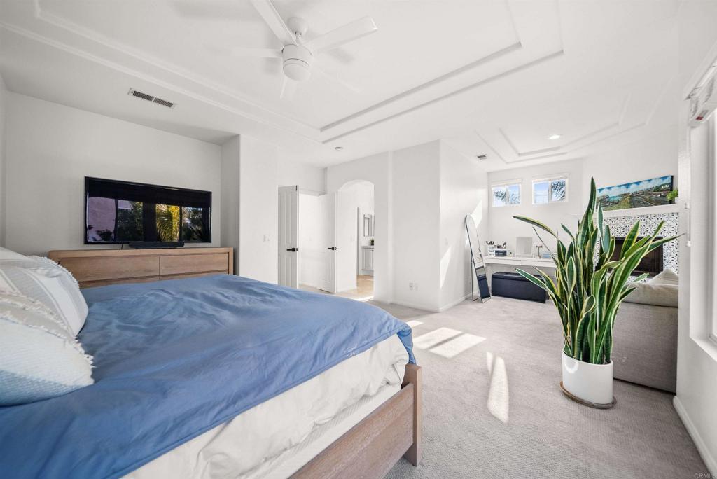 7100 Surfbird Circle Carlsbad, CA 92011 - Photo 40 of 65 a bedroom with a bed and a potted plant