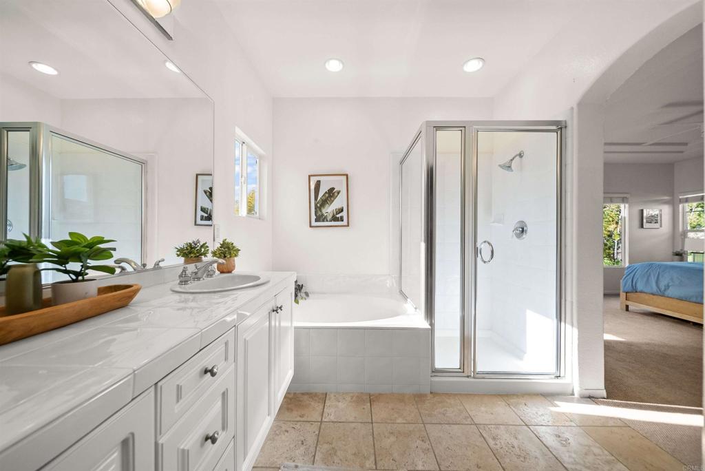 7100 Surfbird Circle Carlsbad, CA 92011 - Photo 43 of 65 a bathroom with a tub sink and mirror