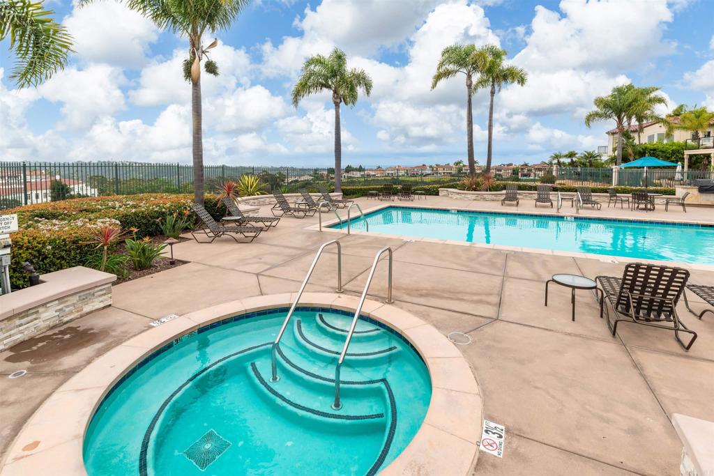 7100 Surfbird Circle Carlsbad, CA 92011 - Photo 56 of 65 a view of a swimming pool with a lawn chairs and a swimming pool