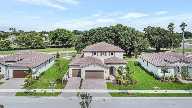 an aerial view of a house with a garden and a yard
