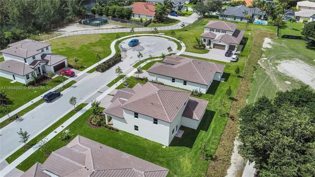 an aerial view of a house with a garden and lake view