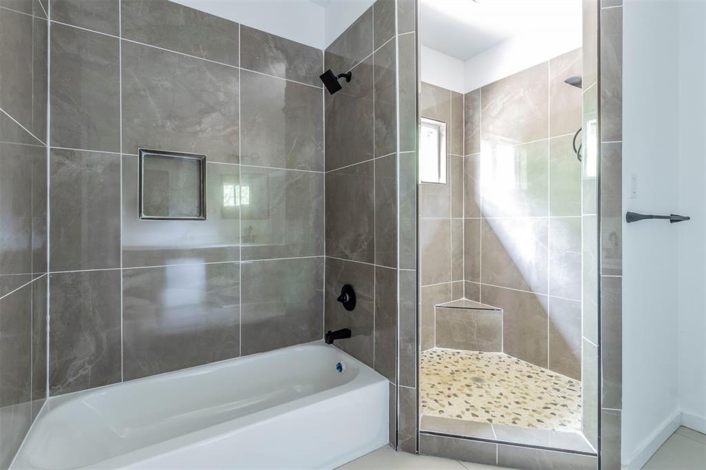 1014 Trinity Street Cleburne, TX 76031 - Photo 11 of 34 Full bathroom featuring a tile shower and a bath