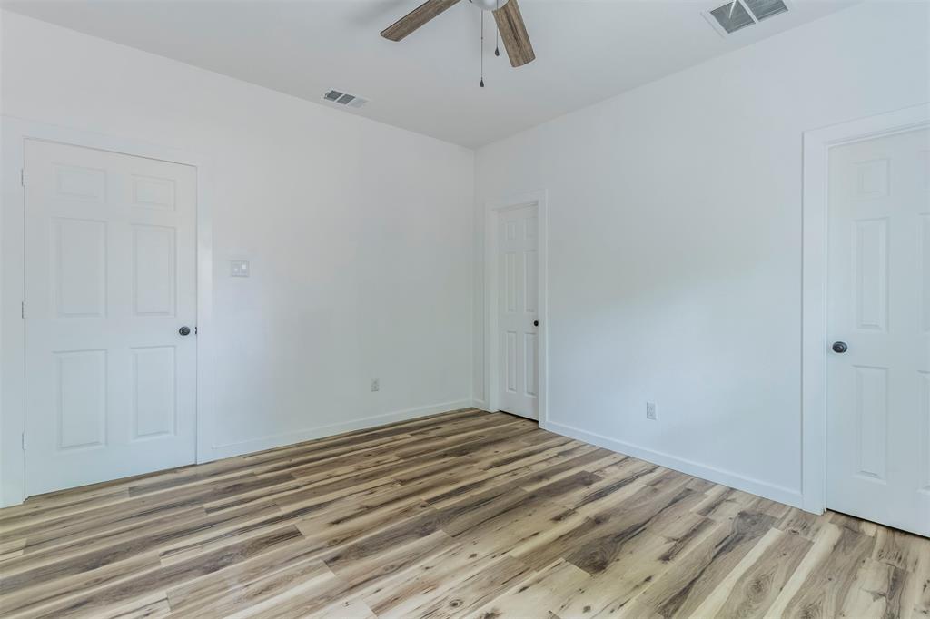 1014 Trinity Street Cleburne, TX 76031 - Photo 13 of 34 Spare room featuring a ceiling fan, light wood-style floors, and baseboards