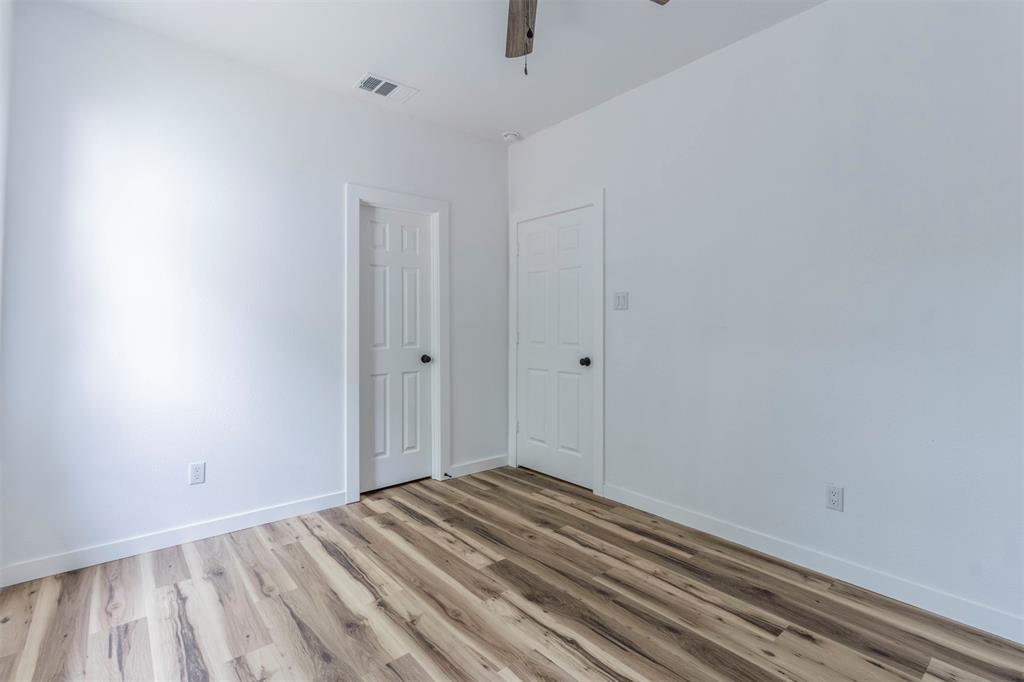 1014 Trinity Street Cleburne, TX 76031 - Photo 19 of 34 Empty room with light wood finished floors, a ceiling fan, and baseboards