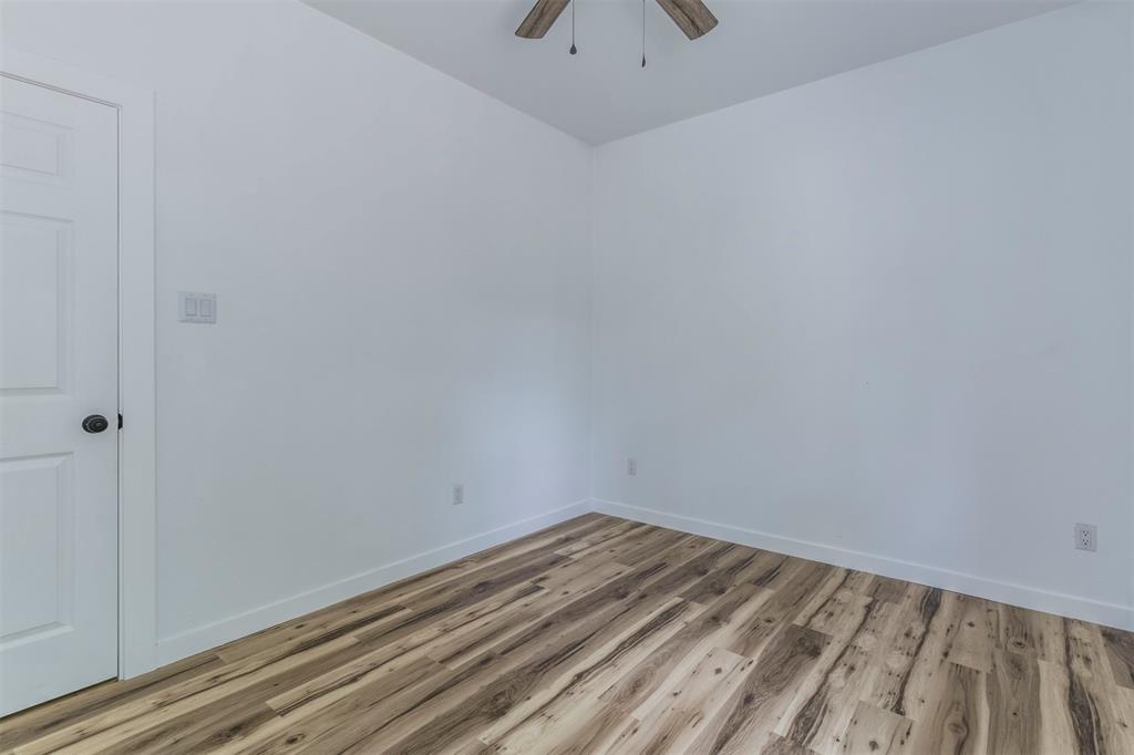 1014 Trinity Street Cleburne, TX 76031 - Photo 20 of 34 Empty room featuring light wood-type flooring, ceiling fan, and baseboards