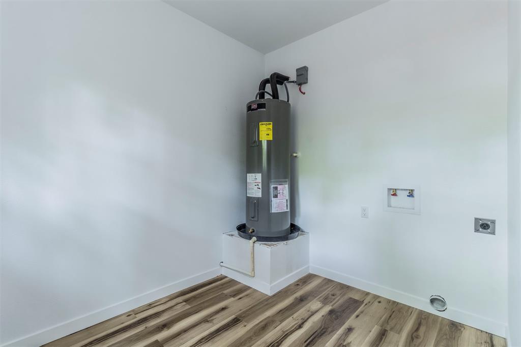 1014 Trinity Street Cleburne, TX 76031 - Photo 22 of 34 Utilities featuring water heater