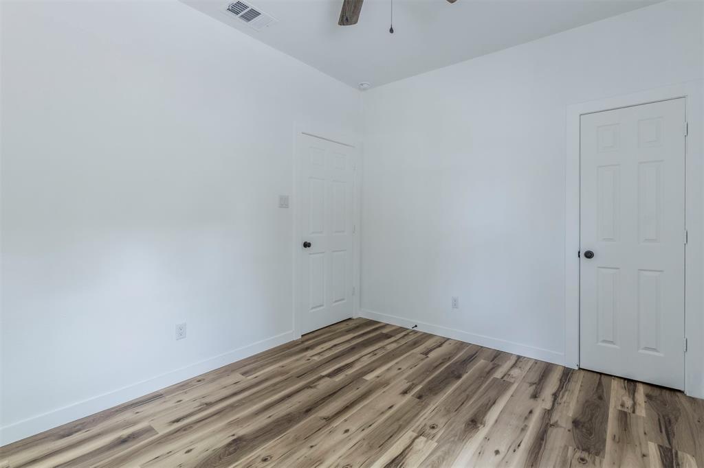1014 Trinity Street Cleburne, TX 76031 - Photo 25 of 34 Empty room with light wood-type flooring, baseboards, and a ceiling fan
