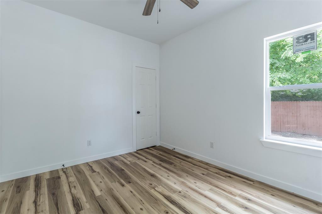 1014 Trinity Street Cleburne, TX 76031 - Photo 26 of 34 Spare room featuring wood finished floors, a ceiling fan, and baseboards
