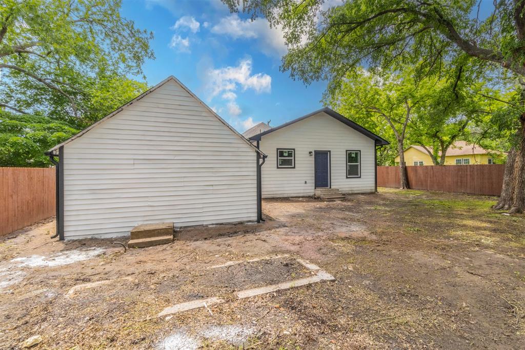1014 Trinity Street Cleburne, TX 76031 - Photo 29 of 34 Back of house featuring entry steps and a fenced backyard