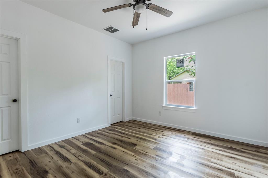 1014 Trinity Street Cleburne, TX 76031 - Photo 5 of 34 Unfurnished room featuring wood finished floors, ceiling fan, and baseboards