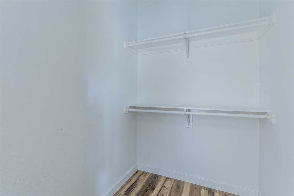 1014 Trinity Street Cleburne, TX 76031 - Photo 8 of 34 Walk in closet with light wood-style flooring