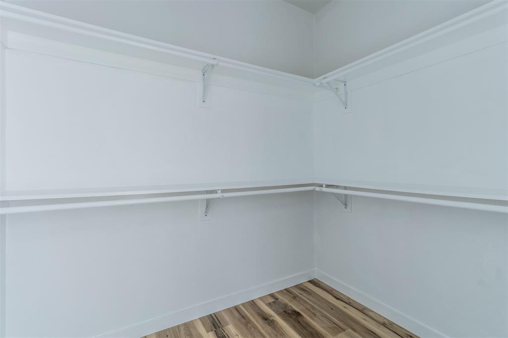 1014 Trinity Street Cleburne, TX 76031 - Photo 9 of 34 Spacious closet with wood finished floors
