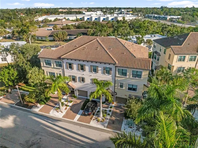 an aerial view of a house with table and chairs