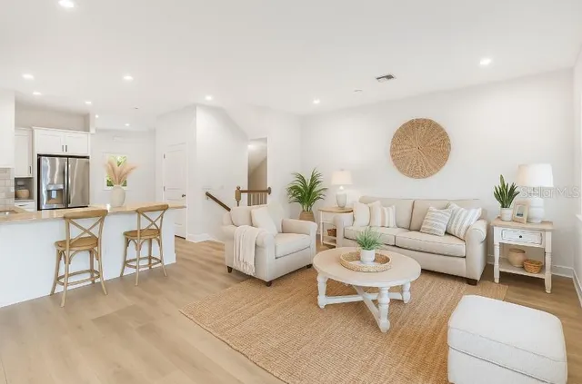 a living room with fireplace furniture and a table