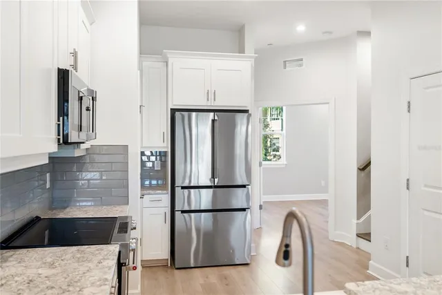 a kitchen with a refrigerator and a sink