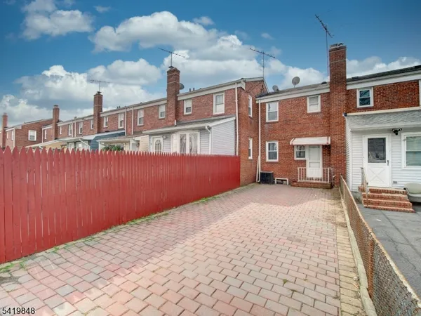 a pathway of a house with a yard
