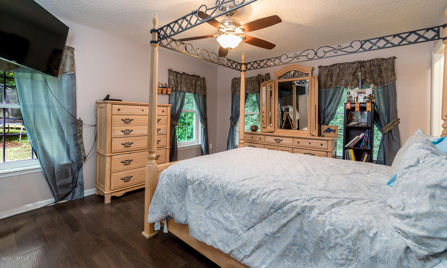 8145 Wendover Road St. Augustine, FL 32092 - Photo 15 of 55 a bedroom with a bed closet and flat tv screen