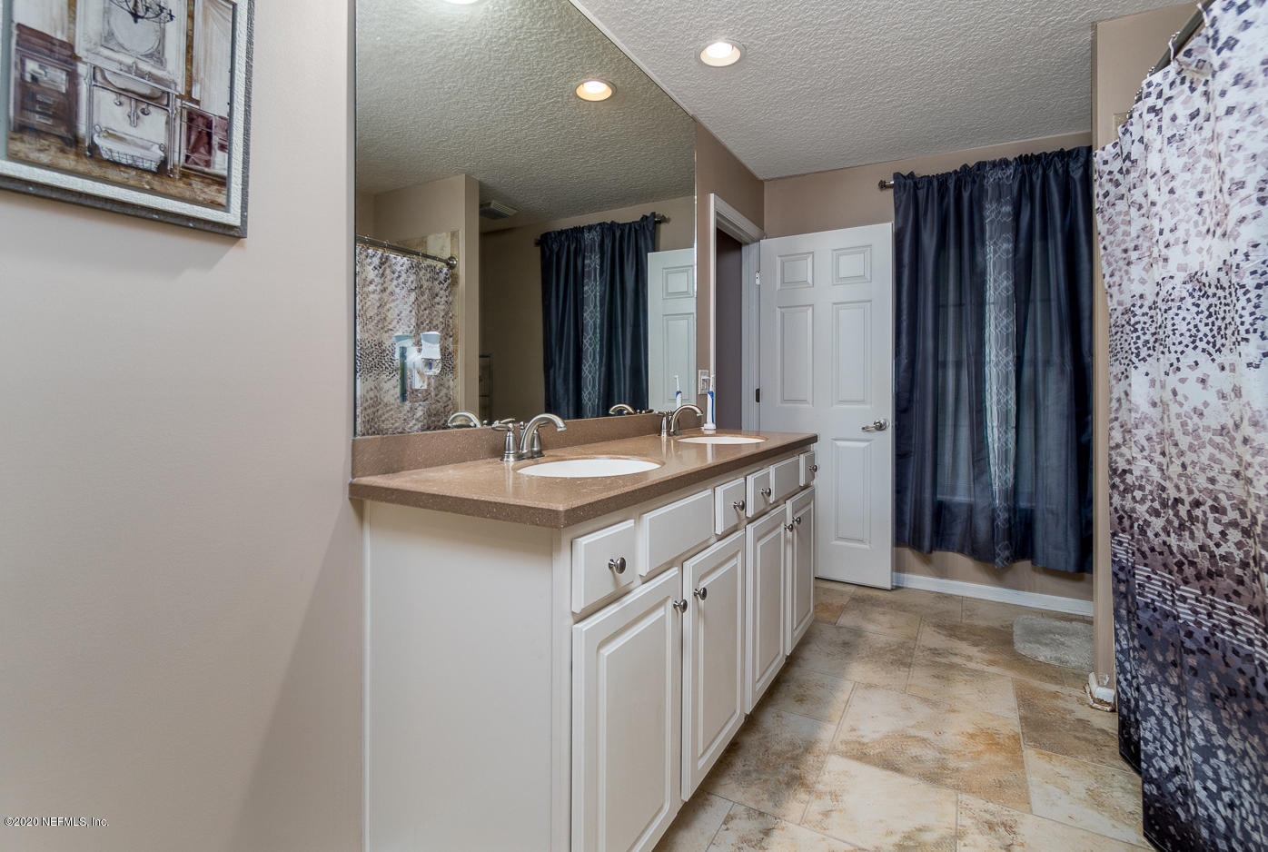 8145 Wendover Road St. Augustine, FL 32092 - Photo 18 of 55 a bathroom with a double vanity sink and a mirror