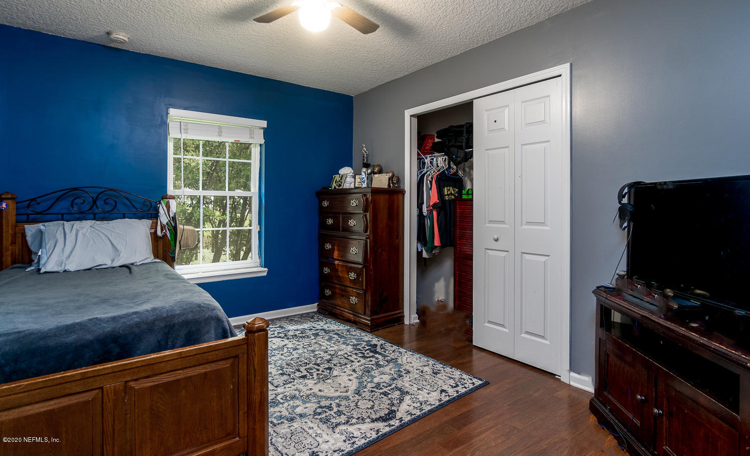 8145 Wendover Road St. Augustine, FL 32092 - Photo 21 of 55 a bedroom with a bed and a television