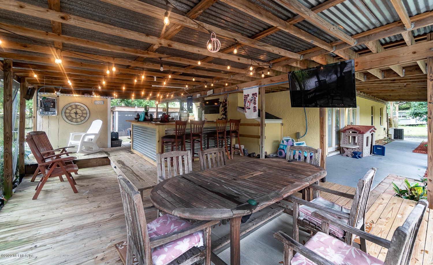 8145 Wendover Road St. Augustine, FL 32092 - Photo 26 of 55 a view of a patio with table and chairs with wooden floor