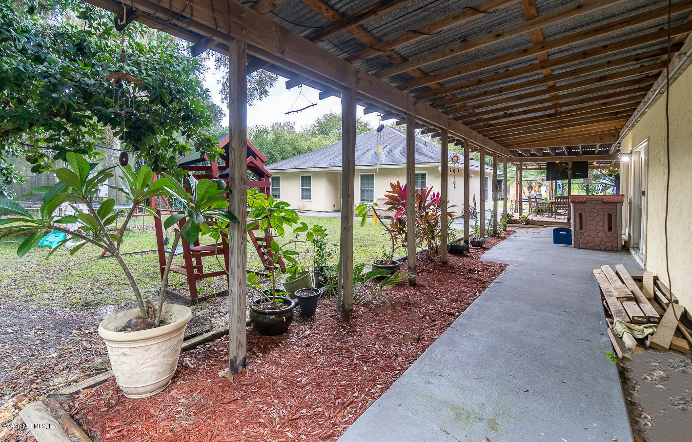 8145 Wendover Road St. Augustine, FL 32092 - Photo 39 of 55 a view of a patio with chairs and plants