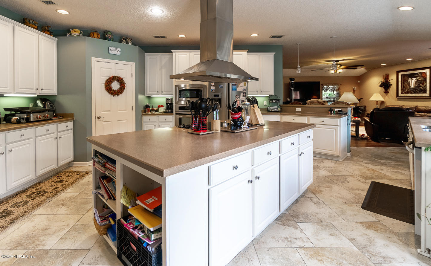 8145 Wendover Road St. Augustine, FL 32092 - Photo 6 of 55 a kitchen with stainless steel appliances granite countertop a table chairs and a refrigerator