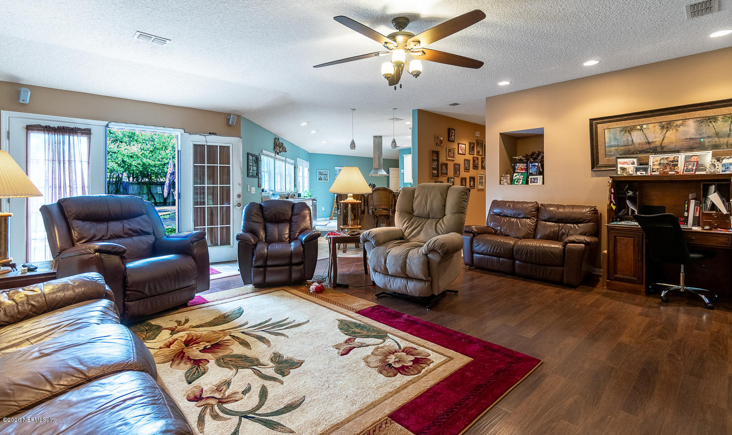 8145 Wendover Road St. Augustine, FL 32092 - Photo 9 of 55 a living room with furniture a flat screen tv and a rug