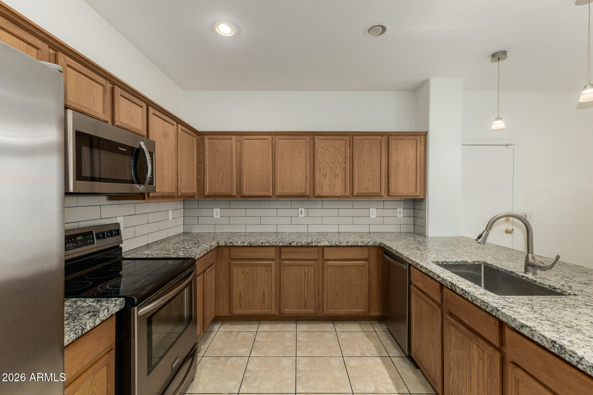 3832 East Jasper Drive Gilbert, AZ 85296 - Photo 10 of 43 a kitchen with a sink stove and microwave