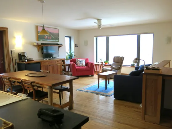 a living room with furniture a window and a dining table