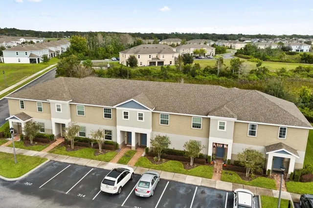 an aerial view of residential houses with outdoor space