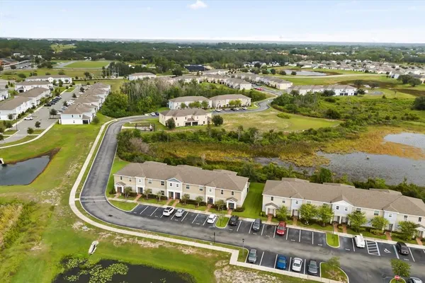 an aerial view of residential house with yard