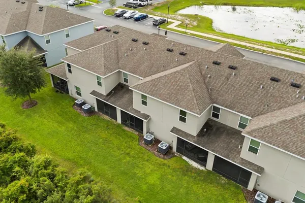 an aerial view of residential houses with outdoor space