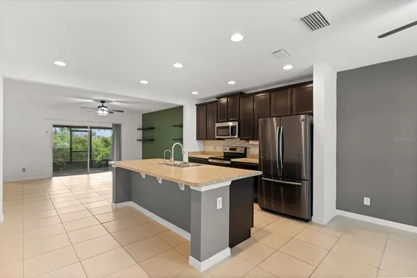 a kitchen with stainless steel appliances granite countertop a refrigerator and a sink
