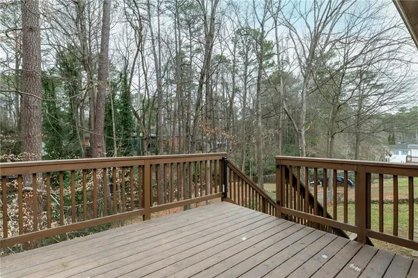 a balcony with wooden floor and fence