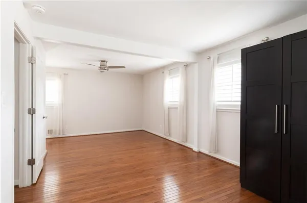 a view of an empty room with wooden floor