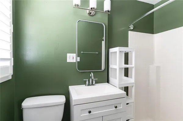 a bathroom with a toilet and a sink