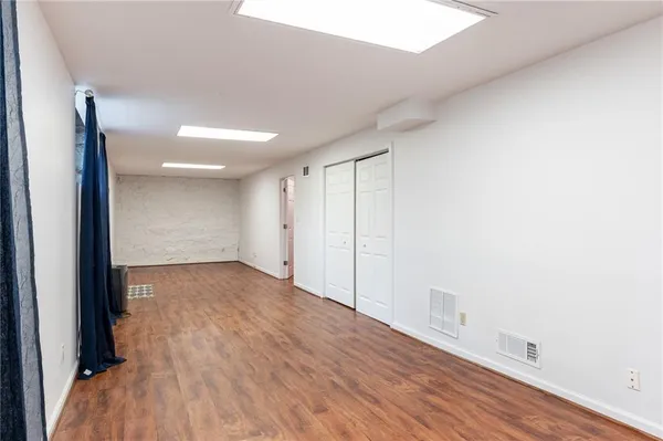 a view of a room with wooden floor